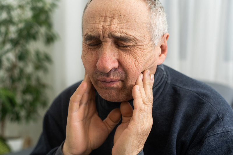 Patient rubbing their jaw due to jaw popping