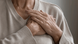 Woman holding her hands over her heart