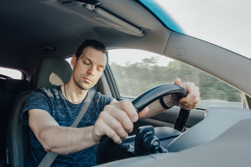 A man falling asleep while driving