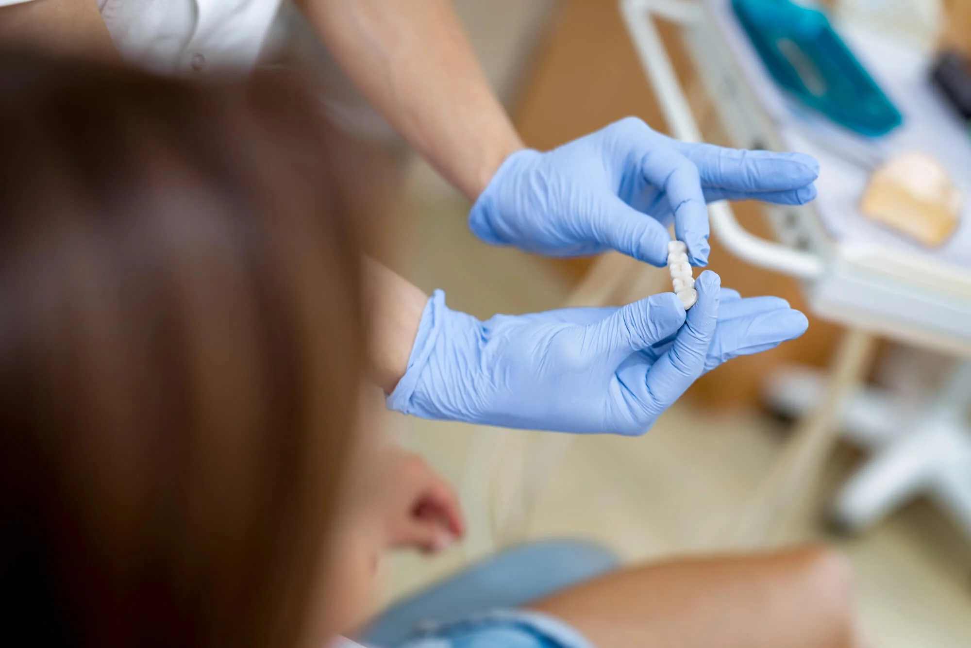 Close-up of a dentist showing dental crowns in Bethesda.