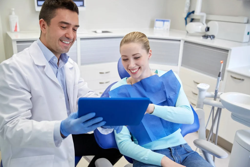 Male dentist in Bethesda, MD providing services to a female patient