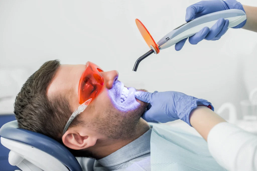 Cropped view of dentist making a Teeth Whitening in Bethesda MD